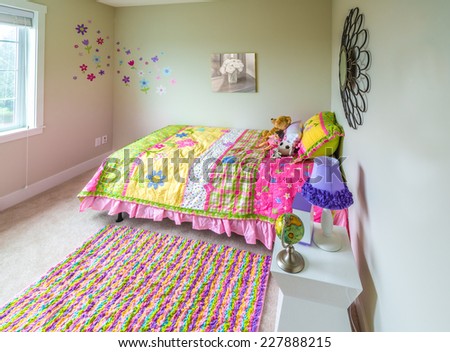 Modern comfortable, nicely decorated children bedroom with some toys. Interior design.