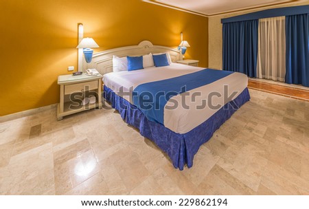 Modern comfortable and elegant master bedroom in a luxury mexican, caribbean  resort hotel. Interior design.