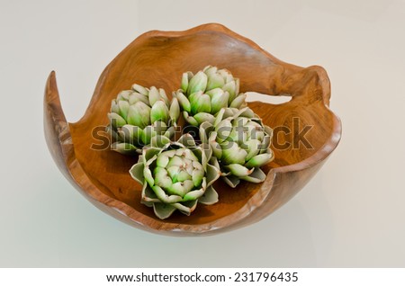 Exotic plant in the wooden vase as an element of interior design decoration.