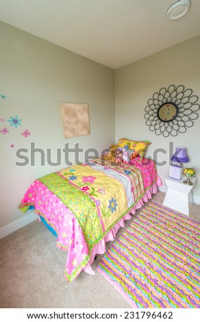 Modern comfortable, nicely decorated bedroom for child with some toys. Interior design. Vertical.