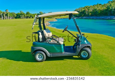 Golf cart at the lake  on the beautiful  golf course of a luxury Mexican resort.