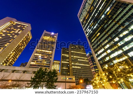 Night scene of modern colorful city life with skyscrapers, highrise buildings. Vancouver downtown  at night.
