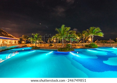 Swimming pool at luxury caribbean resort at night, dawn time. Mexico.