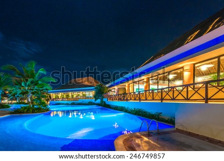 Swimming pool and restaurant at the luxury caribbean resort at night, dawn time. Mexico.