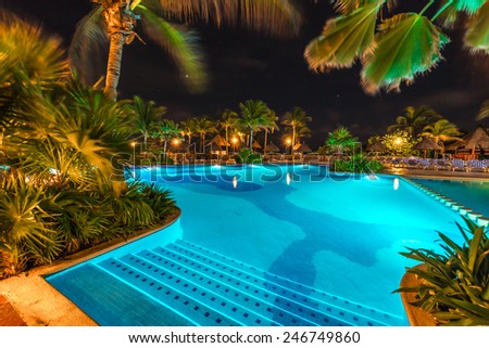 Swimming pool at luxury caribbean resort at night, dawn time. Mexico.