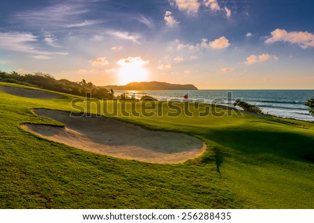 Sand bunkers at the beautiful golf course at the ocean side at sunset, sunrise time.