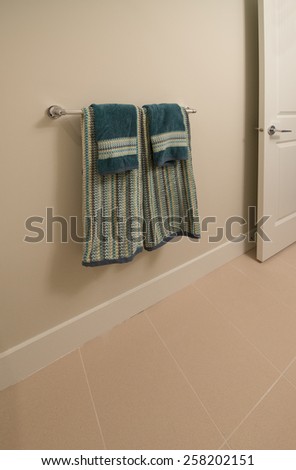 Two towels hanging on the wall of bathroom, washroom.