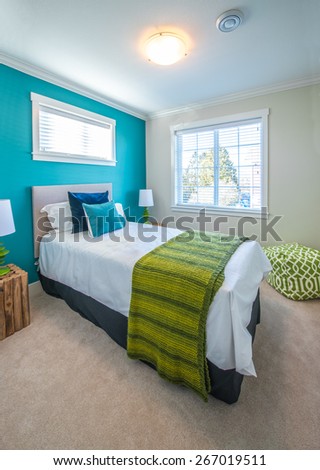 Modern comfortable, nicely decorated children bedroom painted in turquoise. Interior design. Vertical.