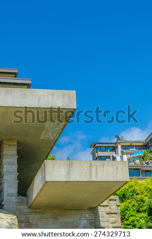 Fragment of the concrete architectural structure of the modern custom build luxury house. Vertical.