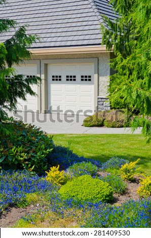 Double doors garage and nicely landscaped front yard. North America.