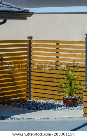 Modern wooden fence separate and protect private property. Vertical.