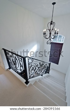 Stairs and handrail  leading to the upper, low level. Interior design. Vertical.