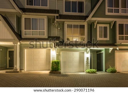 Garages of townhouses, homes, community at  dusk, night time in suburbs of Vancouver, Canada.