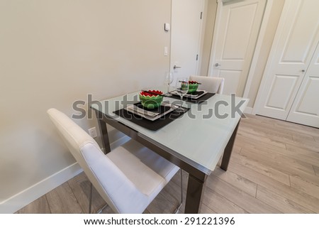 Nicely decorated dining table in the  luxury modern kitchen.  Interior design.