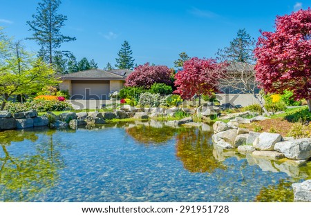 Garage at the pond with nice landscape design. North America. Canada.
