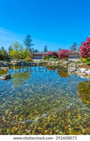 Nicely decorated and designed pond in the great neighborhood of Vancouver, Canada. Landscape design. Vertical.