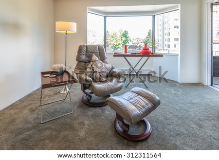 Interior design of luxury nicely decorated modern living room, suite with some leather chairs and coffee table. Interior design.