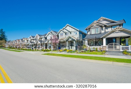 Great neighborhood. Row of the houses, homes on empty street in suburbs of Vancouver, Canada.