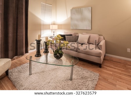 Interior design of luxury nicely decorated modern living room, suite with sofa, coffee table and chairs.