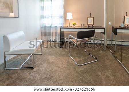 Luxury spacious modern nicely decorated den, home office with the table and the office chair. Interior design.