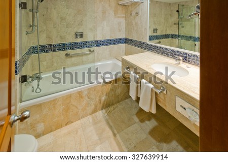 Nicely decorated modern washroom with the toilet and towels in the luxury hotel. Interior design.
