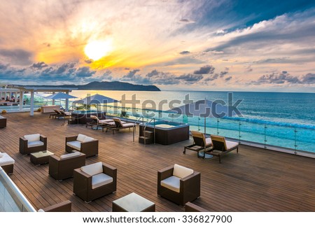 Beautiful tropical, caribbean wooden, flooring ocean beach, resort at sunset, evening, sunrise time.