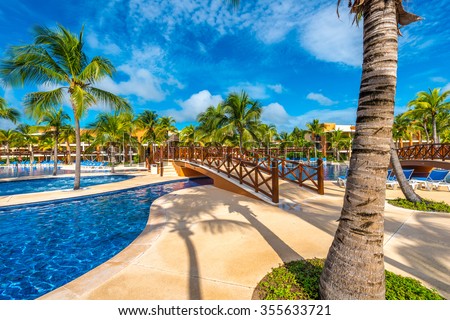 Swimming pool and some lounges at the tropical, caribbean resort.