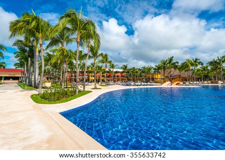Swimming pool and some lounges at the tropical, caribbean resort.