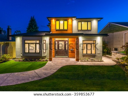 Big luxury, modern house at dusk, night time in suburbs of Vancouver, Canada.