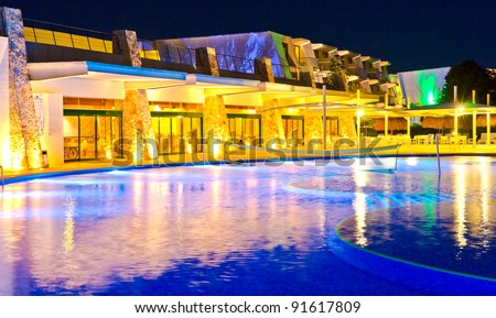 Swimming pool, night, hotel, restaurant. Mexican resort oasis.