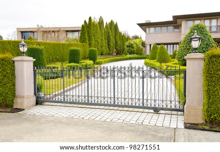 A driveway to the luxury house behind the gates in suburbs of Vancouver, Canada