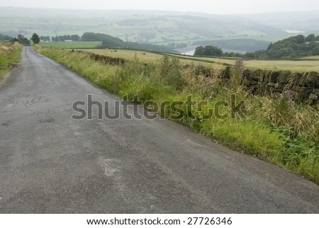 Empty Country Lane Passing through Peak District Rural Landscape, Derbyshire, England