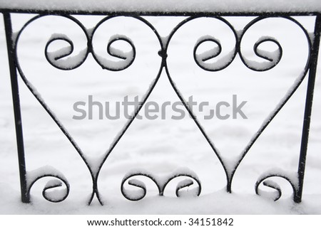Close up on Love Hearts in Chelsea Fence Railing with Winter Snow