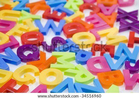Brightly Colored Childrens Toy Magnetic Alphabet Letters on White Background