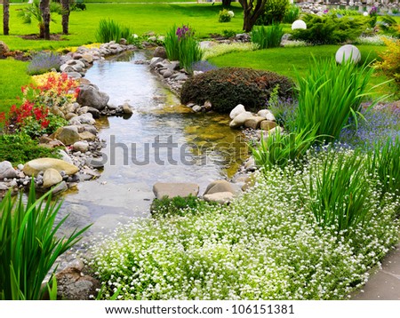 Spring Flowers In The Asian Garden With A Pond