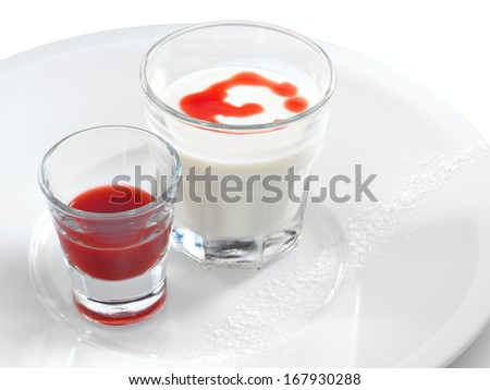 Smooth and creamy panna cotta with strawberry and raspberry sauce in a small glass