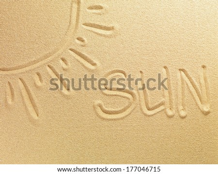 The word Sun is written on sand background and the picture of the sun is painted in the top corner