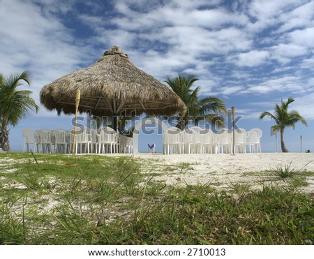 stock photo A lovely beach wedding site under a rustic tiki cabana and on 