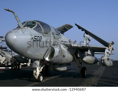 An EA-6B Prowler Electronic Attack aircraft taxies on an aircraft carrier