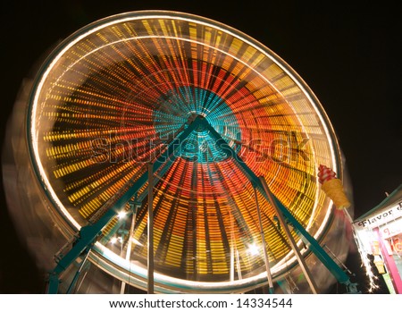 Colorful Spinning Ferris Wheel at Carnival
