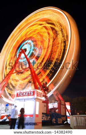 Ferris Wheel, Ticket Stand and people at Carnival