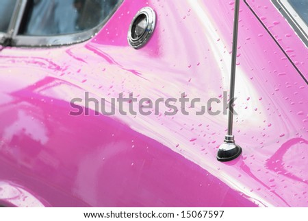The curves and beautiful lines of a classic pink sports car