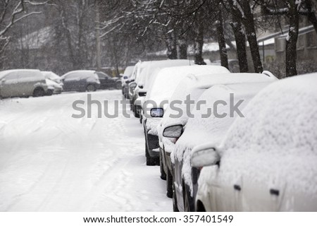 parked cars covered with snow - snow storm
