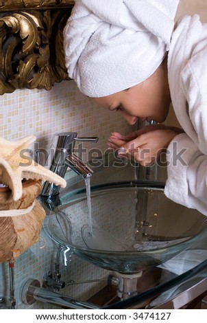 girl washing up her face, spa and wellness concept