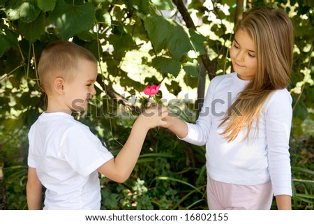 மணம் வீசும் ரோஸ் Stock-photo-preschool-boy-is-giving-a-rose-flower-to-his-girlfriend-16802155