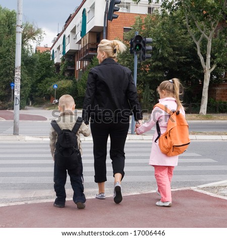 mother taking the children across the street