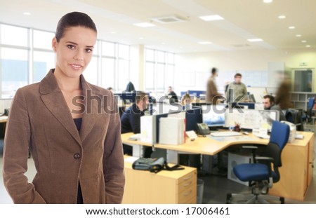 businesswoman standing at the busy office