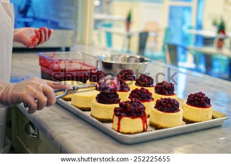 Process of cooking of cheesecake with red berries in the bakery