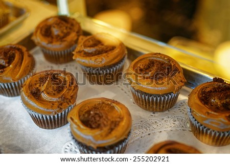 Chocolate cupcakes on the bakery storefront with blurred background