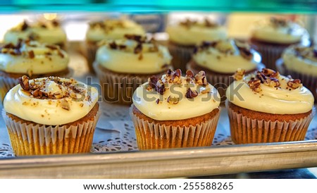 Cupcakes with nuts  on the bakery storefront with blurred background